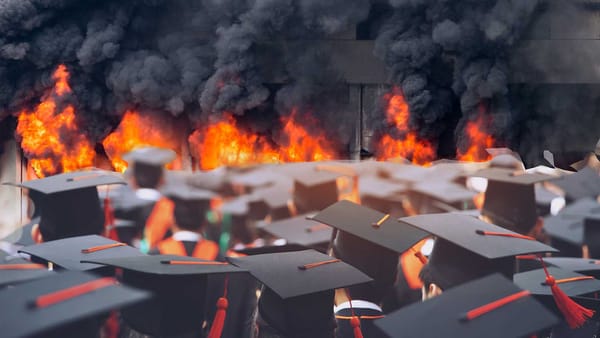 A GROUP OF PEOPLE WEARING COLLEGE GRADUATION MOARTARBOARDS AND GOWNS LOOKING AT A BLAZING CONFLAGRATION BILLOWING BLACK COUL