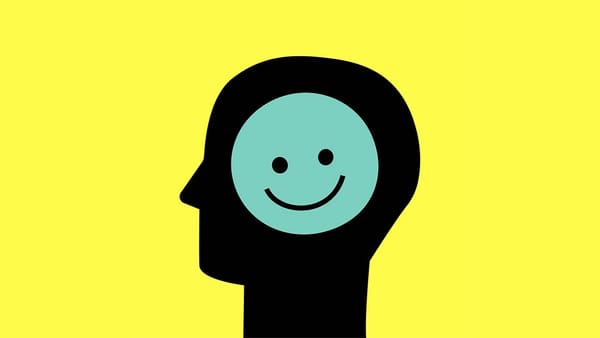 A SIDE-VIEW SILHOUETTE OF A HUMAN HEAD WITH A SMILEY-FACE ICON INSIDE IT