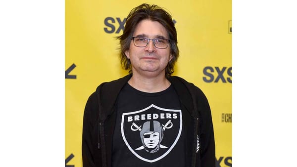 Albini is sporting a BREEDERS t-shirt that looks like a NFL RAIDERS) logo with the pirate in helmet replaced by Kim Deal
