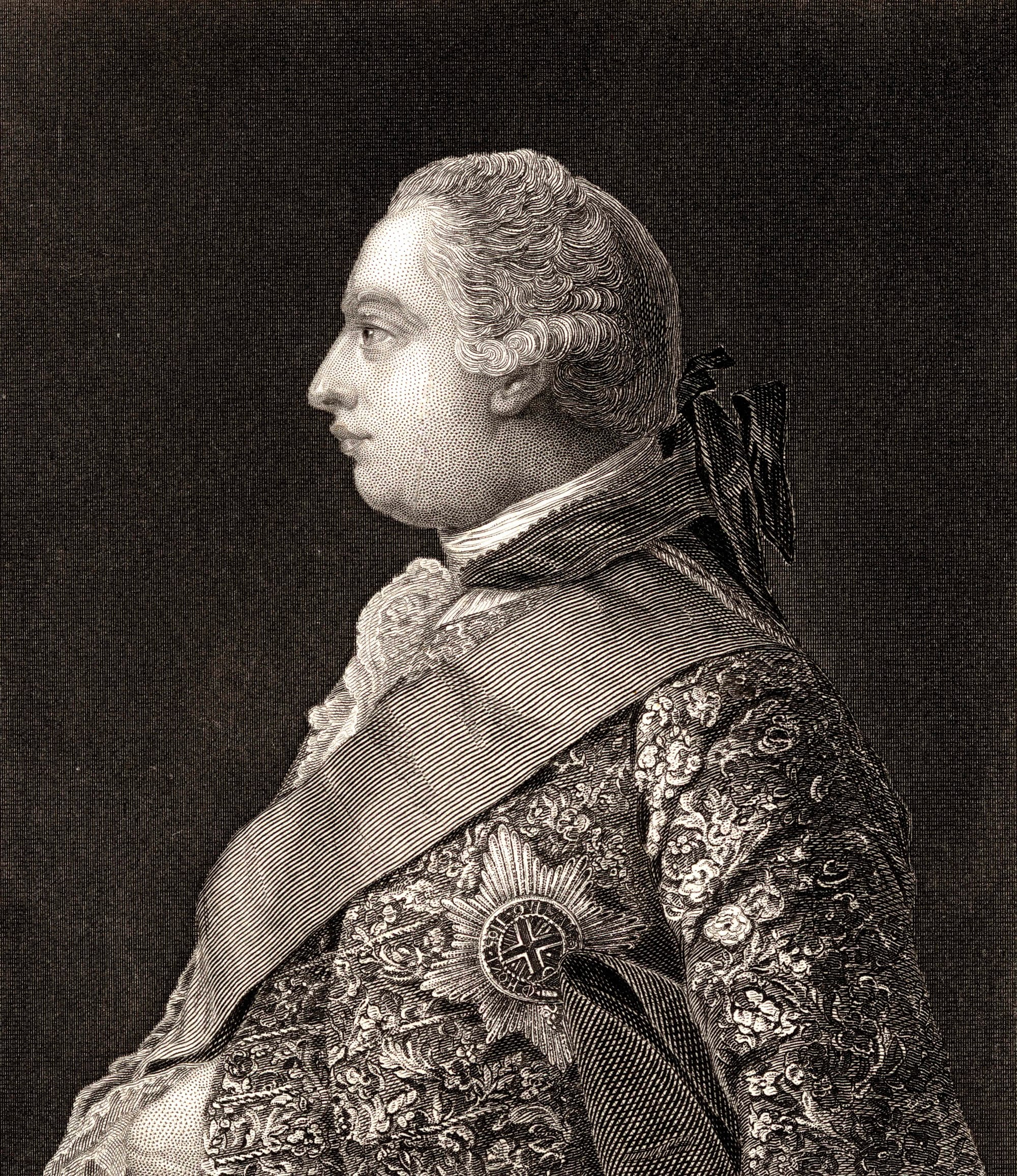 Profile of King George wearing a jacket of fine fabric