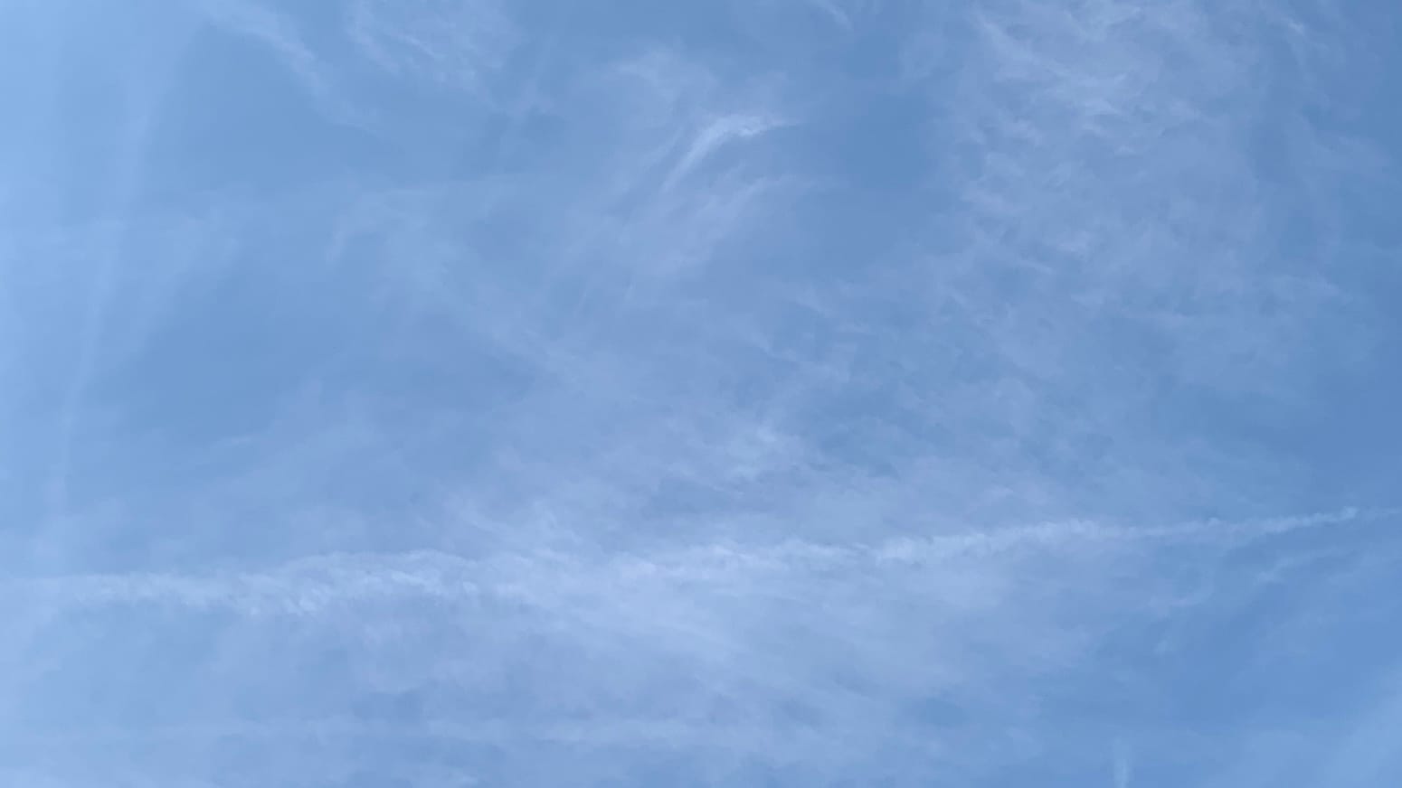 A gauzy application of a flat thin cloud surface with blue showing through and a chalk-line of cloud going horizontally