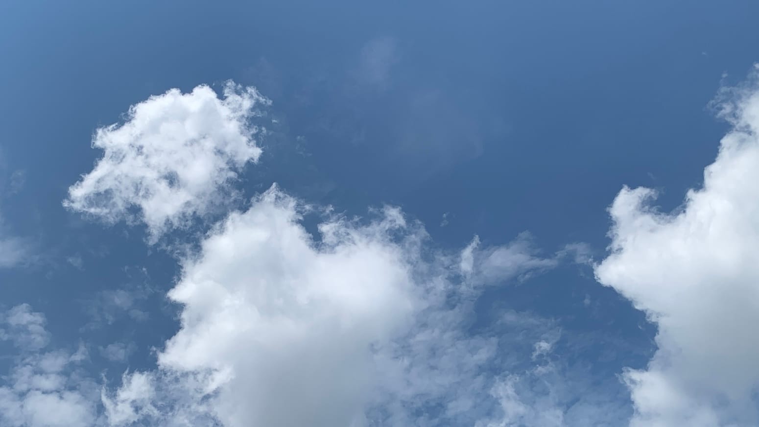 A nice blue sky with cotton-candy clouds