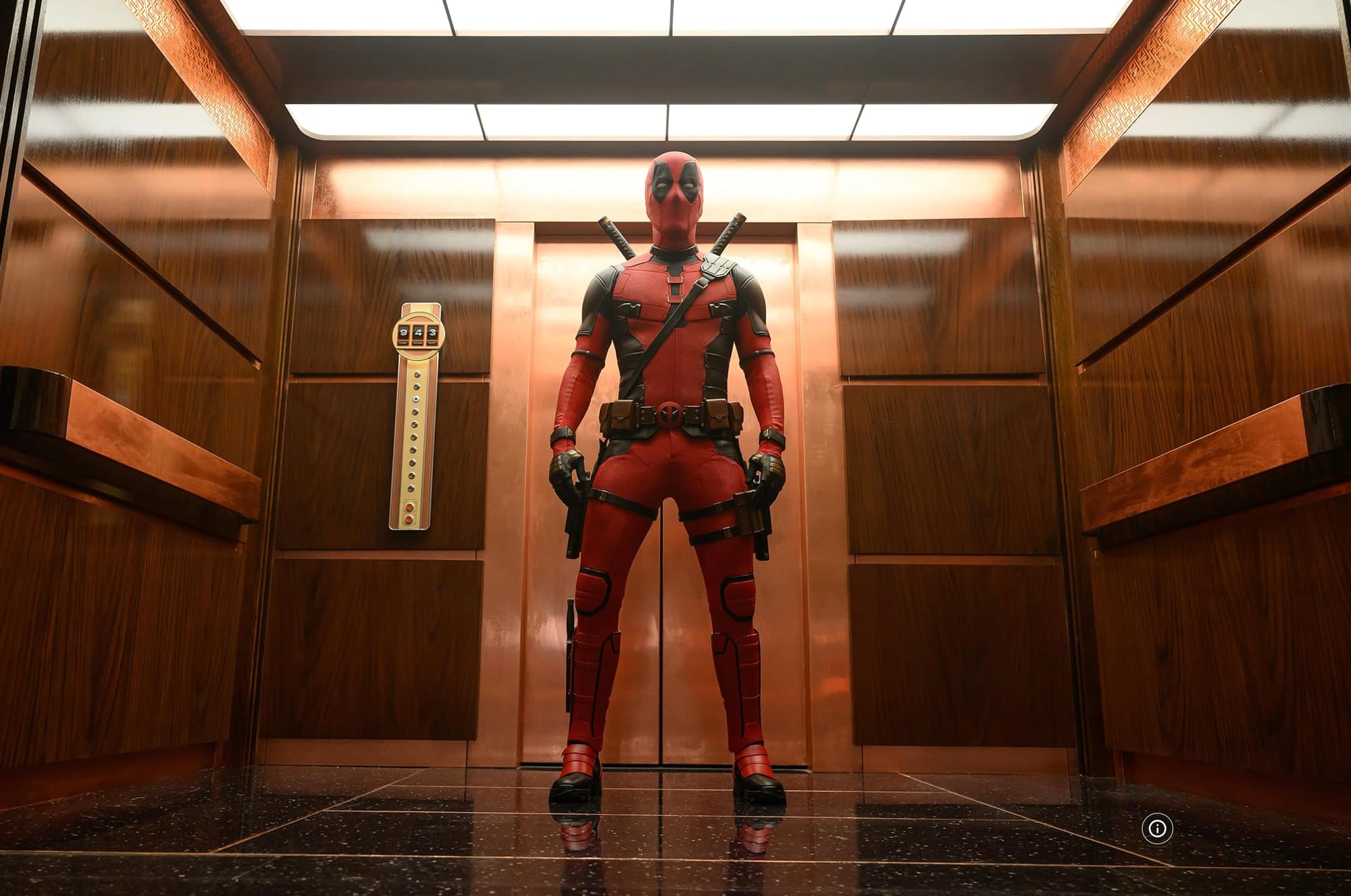 Deadpool standing in a tastefully appointed midcentury modern-style elevator