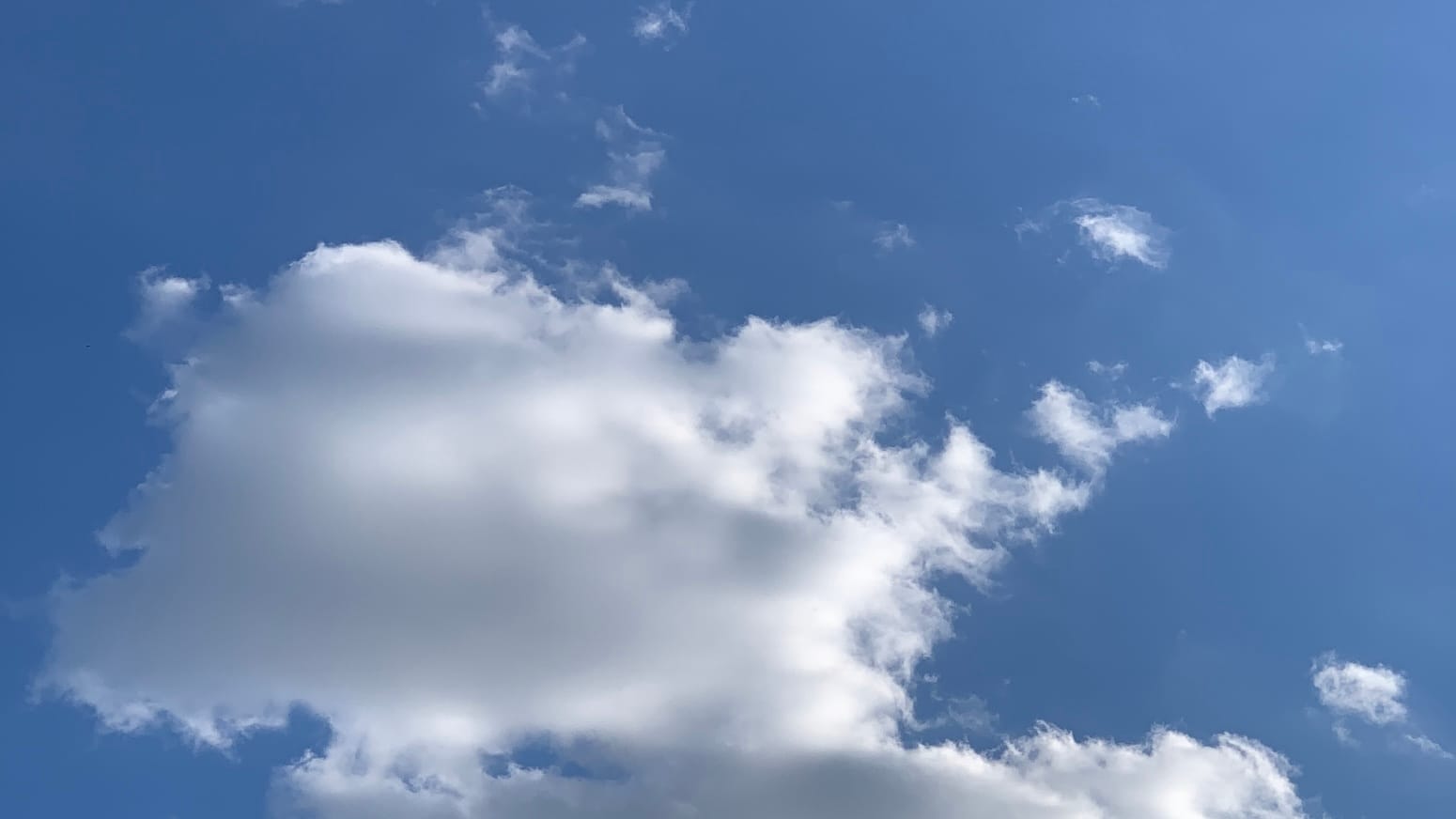 A big raggedy cloud up there on a bright blue day