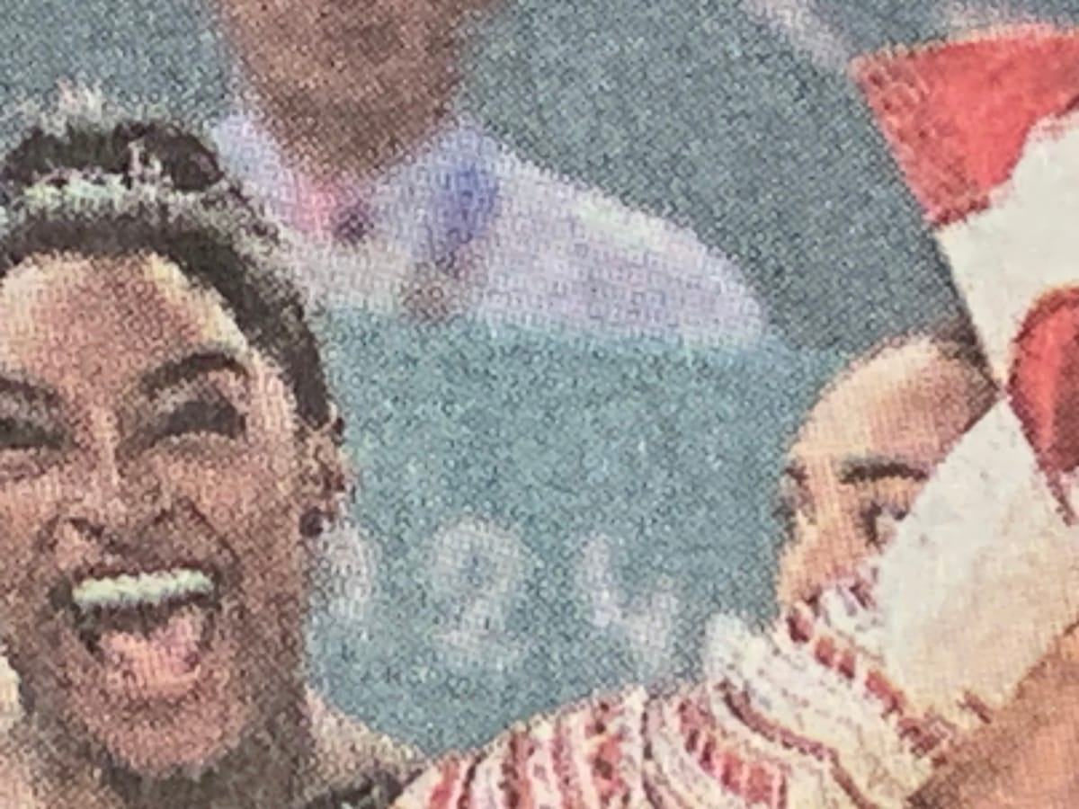 Detail of New York Times photo of U.S. women’s gymnastics team, lead by Simone Biles, celebrating.