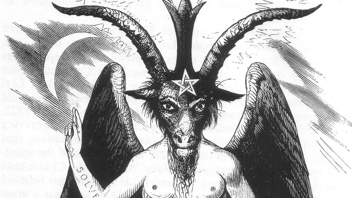 A black-and-white image of the goat-headed, winged Baphomet, from the chest up, raising one hand with two fingers extended to