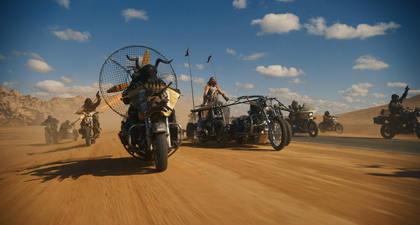 Chris Hemsworth character riding motorcycle chariot made out of at least three motorcycles.