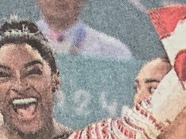 Detail of New York Times photo of U.S. women’s gymnastics team, lead by Simone Biles, celebrating.