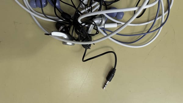 A tangle of old-school cables with an trusty old audio jack sticking out