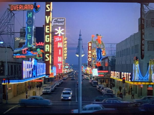 Vegas Strip circa 1960. Neon signs: OVERLAND HOTEL, BIFF'S, THE MINT, HOTEL FREMONT, GOLDEN GATE, and t Golden Nugget cowboy