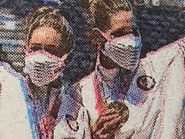 Detail of New York Times photo of Olympians wearing masks because of the COVID, which is still very much a thing.