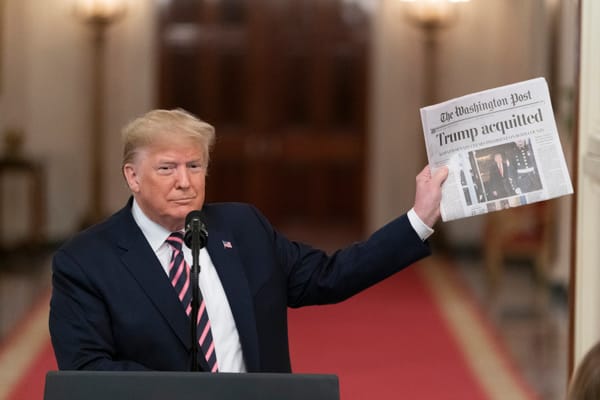 President Donald J. Trump, Feb. 6, 2020 East Room of White House, holding Washington Post with headline "Trump acquitted."