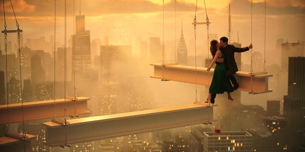 Characters embrace on a girder high above the giant city