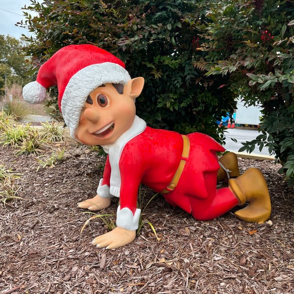 A SMILING XMAS LAWN ORNAMENT ELF ON ITS HANDS AND KNEES READY FOR THE HOLIDAYS