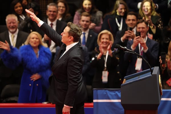 He's totally doing a heil Hitler and there's a bunch of folks in the crowd smiling and applauding.