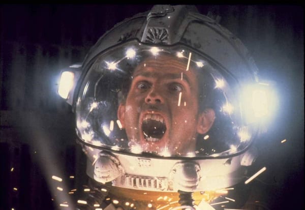 Closeup from the movie of man in space helmet screaming